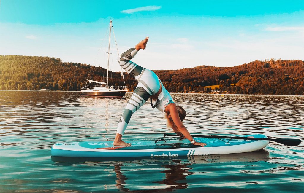 A woman SUP paddleboarding in Cornwall